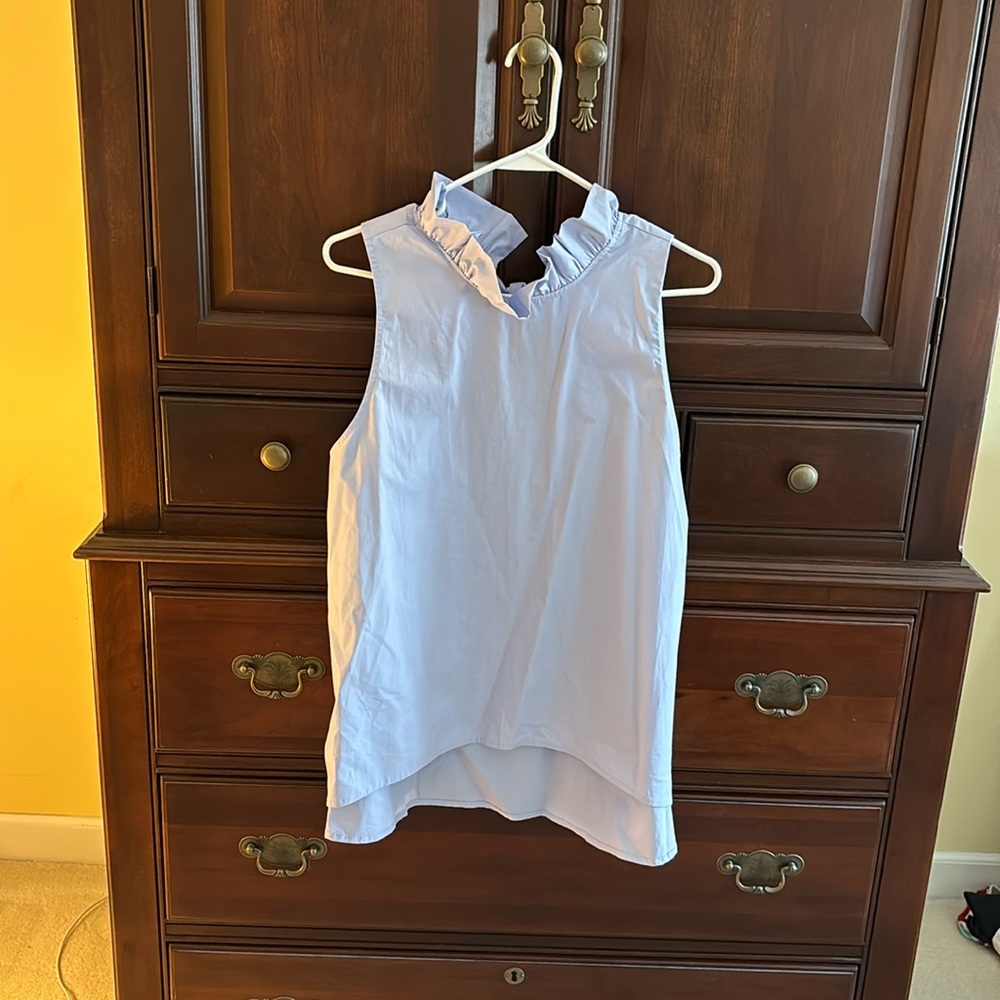 Large Mazik sleeveless ruffle collar top with large tied bow in back.